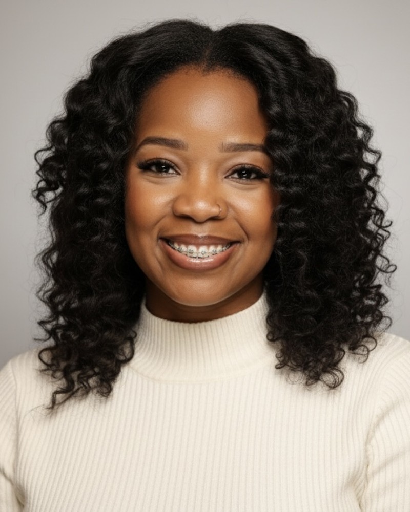 Ashley Estimable, LCSW, smiling, wearing a cream turtleneck sweater